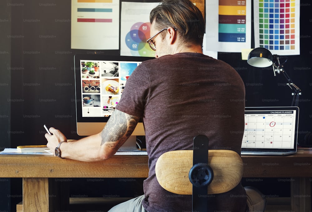 Business owner analysing ecommerce and sales funnel performance on laptop with analytics dashboards and calendar planning tools open at desk